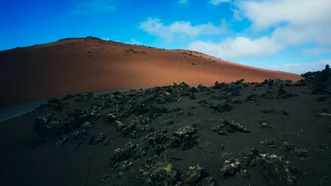 Sunlight moves on the surface of a sand dune and volcanic terrain in Lanzarote Stock Footage 89143610