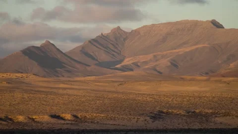 Sunlight moving across desert mountain landscape with clouds timelapse 스톡 동영상 331163367