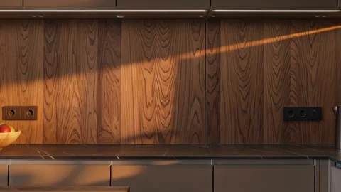 Sunlight moving across a modern kitchen with wooden cabinets and a dark Stock-Footage 335786218