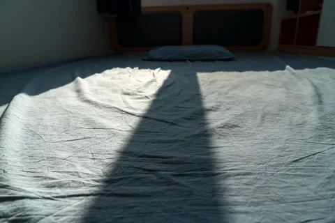 Sunlight moving on the bedsheets in the morning Stock Footage 224312579