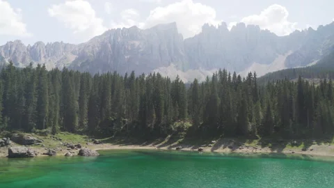 Sunlight moving over carezza lake and latemar mountain in Italian alps Stock Footage 289086752