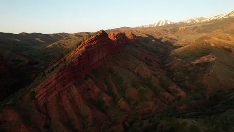 Sunlight moving over mountain range in Kyrgyzstan, aerial view. Stock Footage 288574192