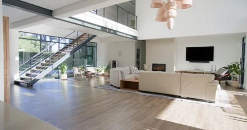 Sunlight is moving through windows lighting beige sofa and rug in living room as Stock Footage 345072513