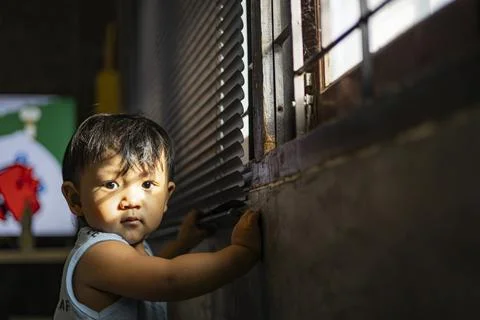 Sunlight Outside The Window Shines On The Face Of A Toddler Stock Photos
