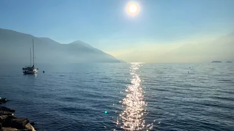 Sunlight Over Alpine Lake with Mountain and Sailing Boat 스톡 동영상 111324015