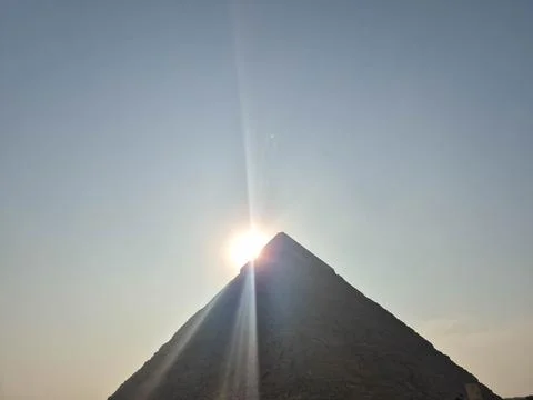 Sunlight over mountain peak with rays and dramatic sky Photos