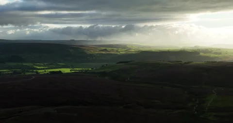 Sunlight over a stormy valley Stock Footage 249595123