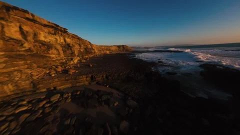 Sunlight paints rugged cliffs in warm tones Stock Footage 339788789