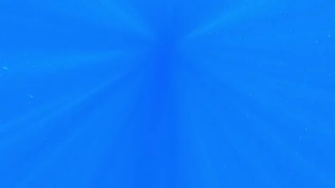 Sunlight passes through the blue water of the sea abyss. Rays of sunlight float Stock Footage 149019891