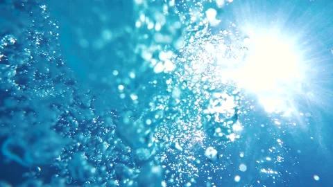 Sunlight passes through water column. Air bubbles rise to surface of water. S Stock Footage 86847342