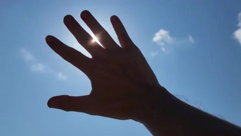 Sunlight passing through fingers Video stock 219710513