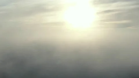 Sunlight passing through a haze of clouds at sunrise. 스톡 동영상 144625814