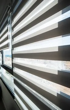 Sunlight passing through zebra blinds in bright modern interior Stock Photos