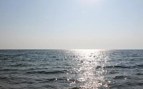Sunlight path on sea surface on a sunny summer day. Vacation minimalistic s.. Stock Photos