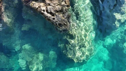 Sunlight Patterns on a Submerged Rock in Clear Turquoise Water Stock Footage 317204018
