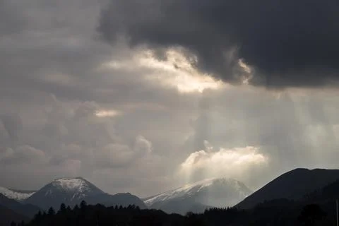 Sunlight peaking through clouds Stock Photos
