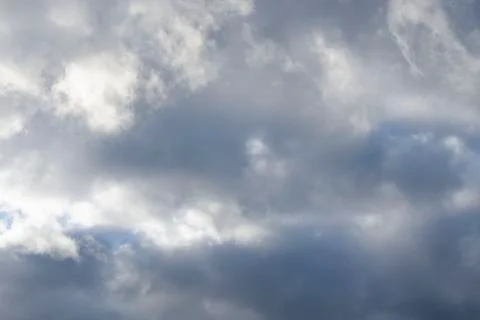 Sunlight peaking through dark clouds Stock Photos