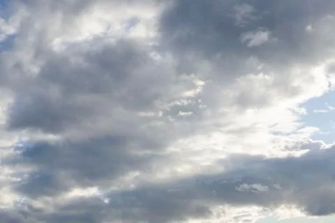 Sunlight peaking through dark clouds Stock Photos