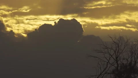 Sunlight pierces through thick clouds in golden hour 스톡 동영상 337799572