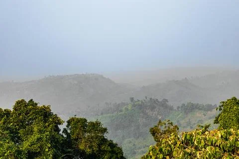 Sunlight piercing clouds over Sajek forest Stock Photos