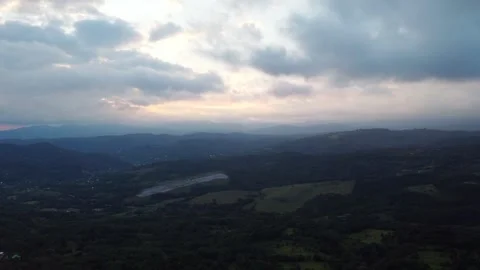 Sunlight piercing through clouds on a stunning mountain landscape with a natural Stock Footage 265931700