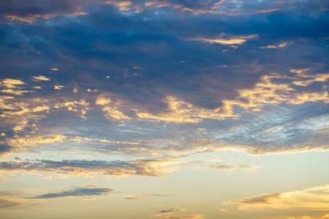 Sunlight piercing through dramatic clouds at sunrise or sunset. Stock Photos