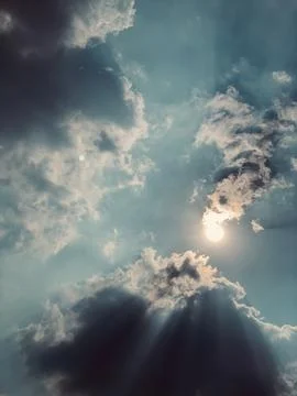Sunlight Piercing Through Dramatic Clouds in an Atmospheric Sky Stock Photos