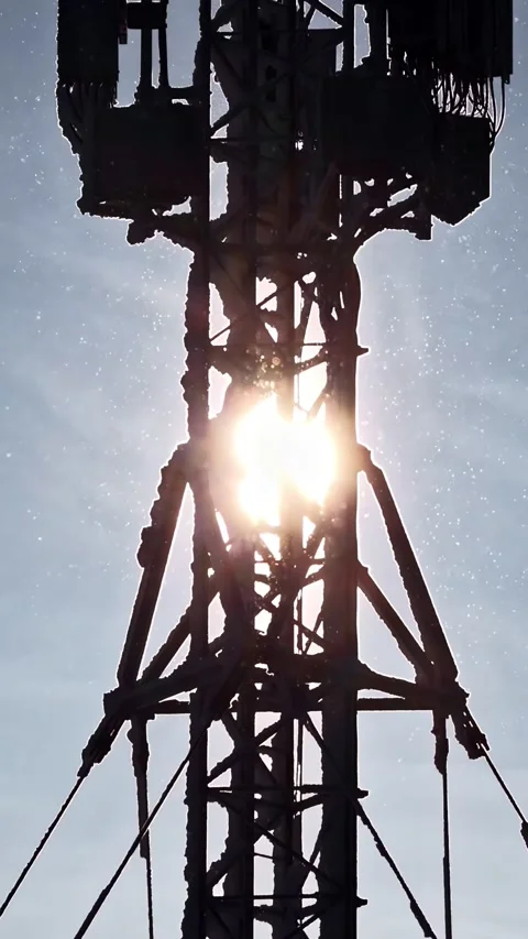 Sunlight Piercing Through Frost-Covered Communications Tower Stock Footage 336662383