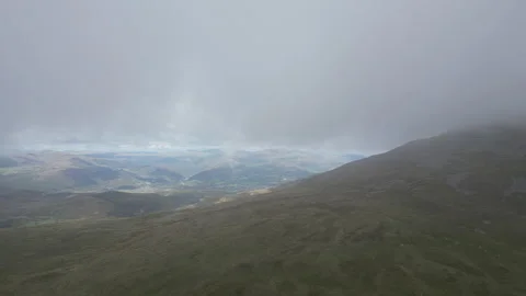 Sunlight piercing through misty peaks on a vast mountainous valley. Stock Footage 314347350
