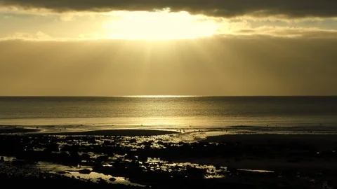 Sunlight pours through sky onto sea with birds in foreground Vídeos de archivo 100566019