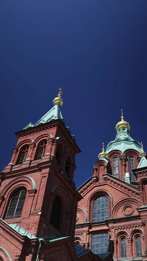 Sunlight rays across Uspenski Cathedral red brick architecture in Helsinki Stock Footage 346545272