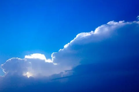 Sunlight rays from the clouds on a blue sky Stock Photos