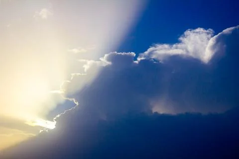 Sunlight rays from the clouds on a blue sky Stock Photos