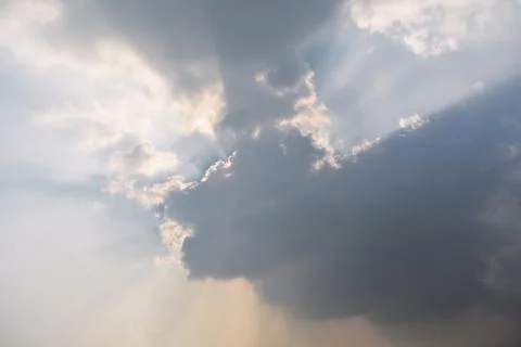 Sunlight rays coming out between the clouds Stock Photos