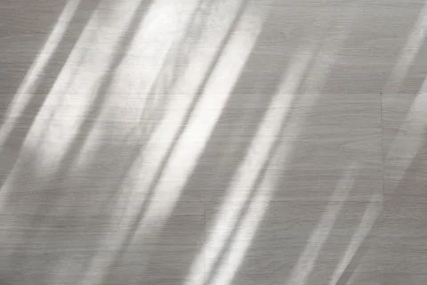Sunlight rays on light wood floor, abstract shadow pattern, minimalist interi Stock Photos