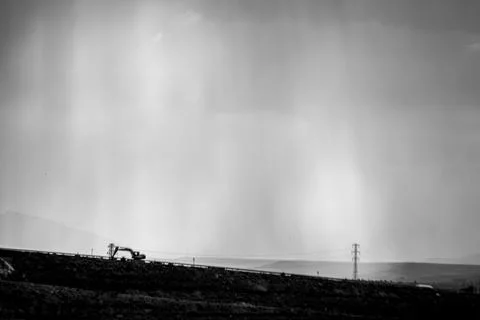 Sunlight rays over minimalistic construction machinery, perfect for backgroun Stock Photos