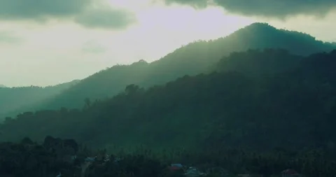 Sunlight Rays Over Tropical Mountain Ridge with Atmospheric Morning Haze Stock Footage 336948167
