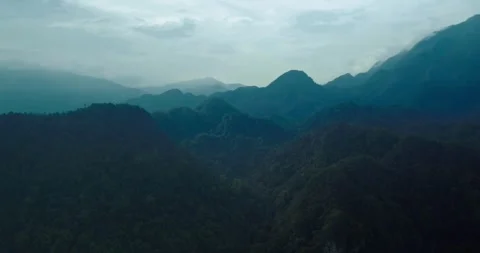 Sunlight Rays Over Tropical Mountain Ridge and Jungle Landscape Stock Footage 336948622
