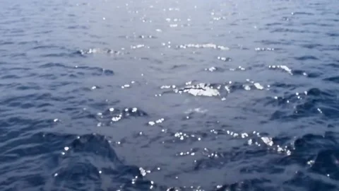 Sunlight reflecting on calm ocean water Stock Footage 230200475