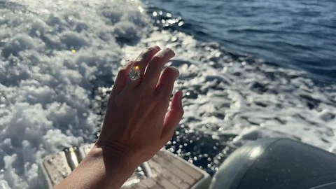 Sunlight reflecting on diamond ring above bright blue Mediterranean sea Stock Footage 319406924