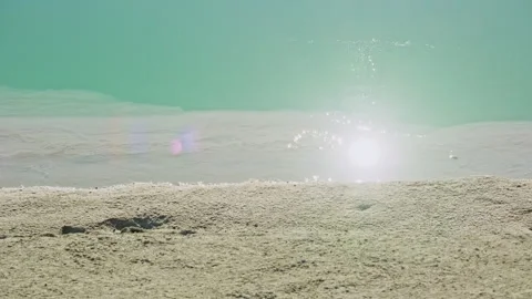 Sunlight reflecting on emerald green salt lake Stock Footage 326232972