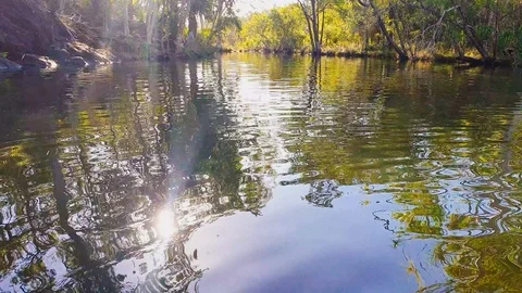 Sunlight reflecting off gently moving water in rock pool Stock Footage 122356385