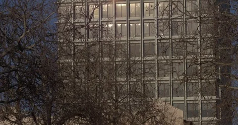 Sunlight reflecting on glass window shield of building Stock Footage 84514919