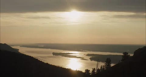 Sunlight reflecting on river at sunset with islands Stock Footage 304299796