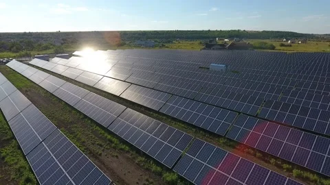Sunlight is reflecting in the solar panels at a solar power station, evening Stock Footage 160112529