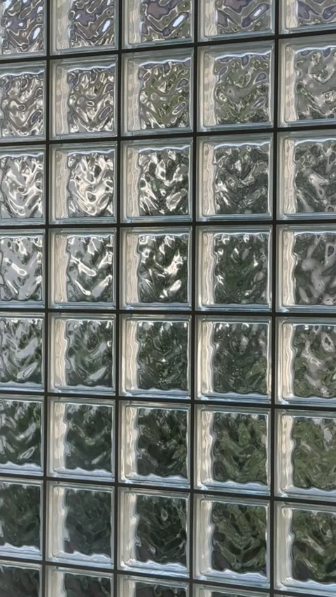 Sunlight reflecting off textured glass wall creating dynamic patterns Stock Footage 315524680