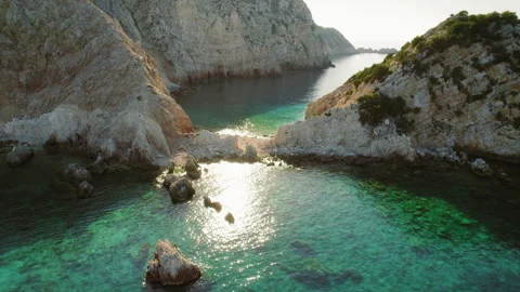 Sunlight reflecting on turquoise waters between cliffs on summer day in Greece Stock Footage 310420550