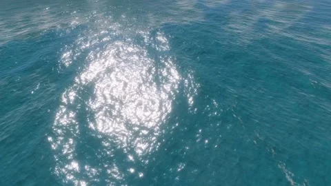 Sunlight reflecting on the undulating surface of calm blue ocean. Stock Footage 283473842
