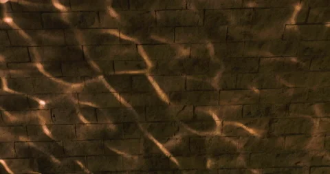 Sunlight reflecting off of water on to a brick wall in slow motion Stock Footage 133700230