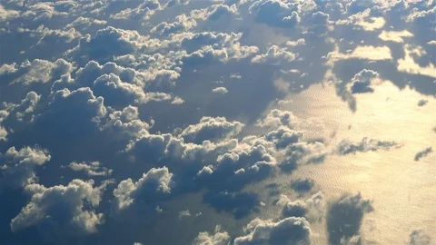 Sunlight reflecting off water, flying high above the clouds aerial view Stock Footage 98555780